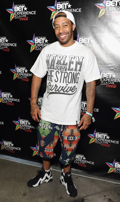 Bones Brigante - 106 &amp; Park's Freestyle Champion Bones Brigante&nbsp;gets his shine on as he walks through the event. The Bronx emcee reps for New York with a &quot;Harlem Only the Strong Survive&quot; T-shirt.&nbsp;(Photo: Angela Weiss/BET/Getty Images for BET)
