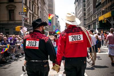 Newlyweds Show Their Love - Two men dressed in cowboy hats wore &quot;Just Married&quot; signs and showed off their new union by holding hands in the parade.&nbsp;(Photo: Andrew Burton/Getty Images)