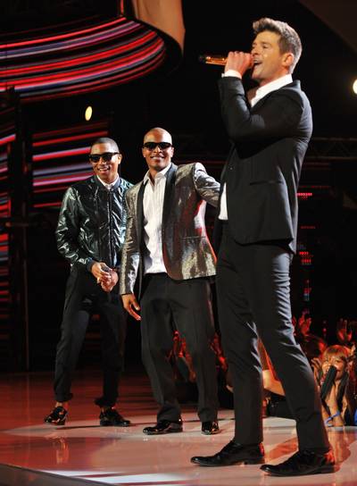 Robin Thicke, Featuring T.I. and Pharrell – &quot;Blurred Lines&quot; (2013) - For what would become one of the most ubiquitous songs in recent memory, Robin Thicke brought T.I. and Pharrell aboard for &quot;Blurred Lines.&quot; The Grand Huslte boss' flow once again paired perfectly with Pharrell's production, which deserves much credit for the single's success.&nbsp;(Photo: Kevin Mazur/Getty Images for BET)