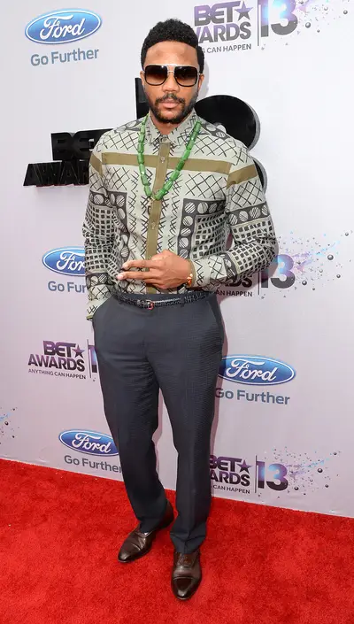 Chill - The Game's Hosea Chanchez, aka Malik, goes for a casual look with a patterned button down and slacks. He adds a statement green necklace to complete the look.  (Photo: Jason Merritt/BET/Getty Images for BET)