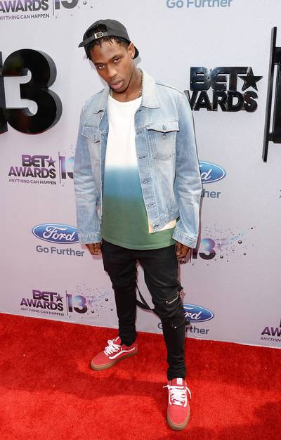 Throwback - Travis Scott takes it back a few decades with the dip-dyed shirt and faded jean jacket for the Ford Red Carpet.  (Photo: Jason Merritt/BET/Getty Images for BET)