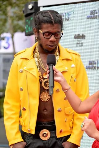Golden Boy - Trinidad James said he wanted to go for a chill vibe, which he achieves with a shirtless look topped by a bright yellow MCM jacket, leather pants and lots of gold.  (Photo: Alberto Rodriguez/BET/Getty Images for BET)