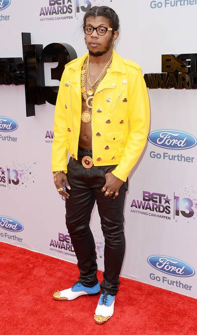 Yellow Gold - Rapper Trinidad James is not afraid to make a statement and in his first look of the night, he rocks a yellow MCM leather jacket with no shirt, at least six gold chains, numerous rings, studded oxfords and black leather pants.  (Photo: Jason Merritt/BET/Getty Images for BET)