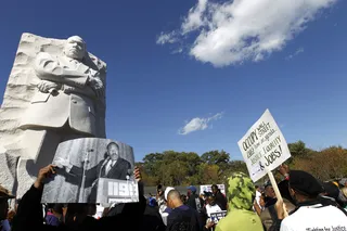 Know Your Rights - Demonstrators hold up a photograph of Martin Luther King Jr. at the jobs and justice march. National Urban League President Marc Morial warned protesters earlier in the day to make sure they are aware of any changes to voting rules in their home states so they are not disenfranchised.(Photo: AP Photo/Jose Luis Magana)