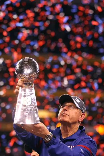 Sharing It With the Fans - Giants head coach Tom Coughlin salutes the crowd with the team's hard-earned Vince Lombardi Trophy. The Giants came back from a 7-7 record near the end of the season to win the championship. (Photo: Al Bello/Getty Images)