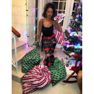 Rihanna @badgalriri - Another Santa impersonator! Rih Rih lugged sacks of presents to the tree in her festive island attire for her holiday in Barbados with her family.&nbsp;(Photo: Rihanna via Instagram)