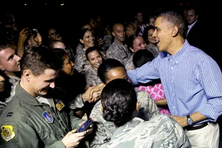 The Welcoming Committee - The president greets members of the military there to welcome the first family to Hawaii.  (Photo: Carolyn Kaster/AP Photo)