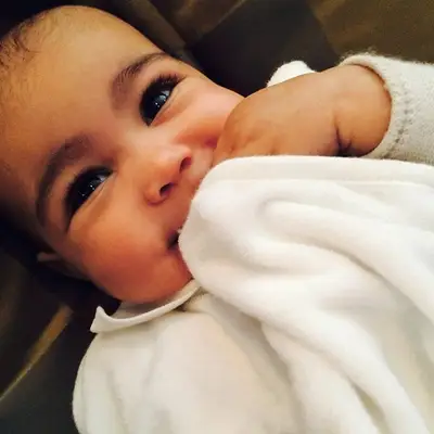 Kim Kardashian @kimkardashian - Kim caught little Nori trying hide a big beautiful smile. This tot's grin will make anyone's heart melt, no wonder Kanye West is in love with his baby girl!(Photo: Kim Kardashian via Instagram)