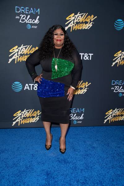 Kim Burrell sparkled in a curve-hugging black dress, featuring eye-catching sequin patches. - (Photography By Gip III for Central City Productions) (Photography By Gip III for Central City Productions)
