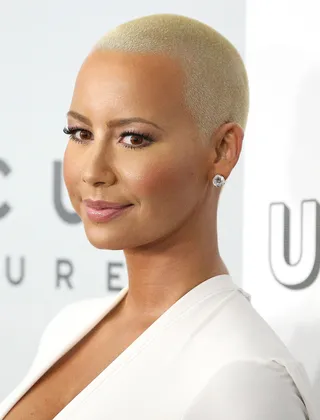 15 Things You Didn't Know About Amber Rose - Our favorite hair barely there beauty has many sides that we have yet to know or understand. Just what's underneath Miss Rose's petals? Hmmm.  (Photo: Imeh Akpanudosen/Getty Images)