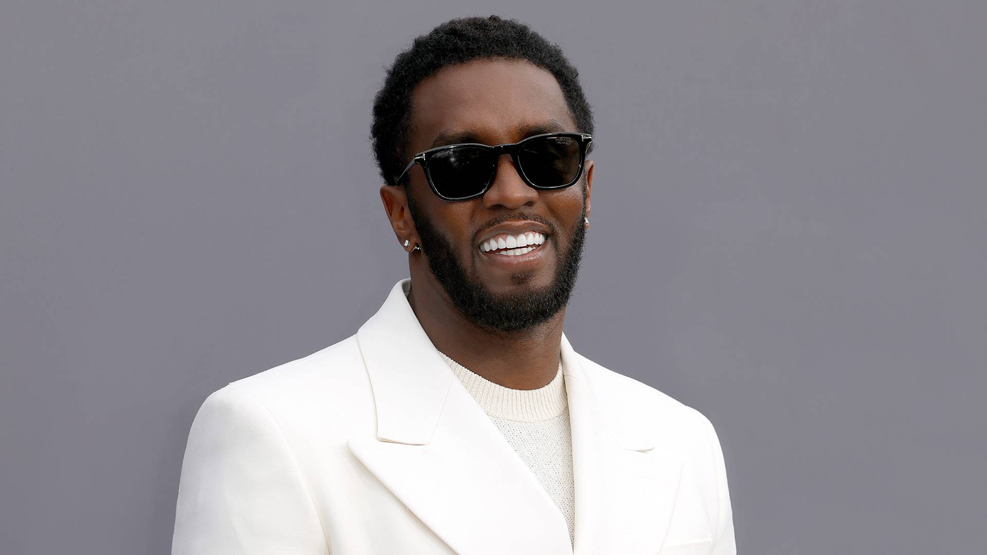 Diddy shines in an all-white suit at the 2022 Billboard Music Awards. (Photo by Frazer Harrison/Getty Images)