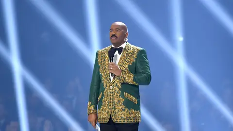 ATLANTA, GEORGIA - DECEMBER 08: (EDITORIAL USE ONLY) Steve Harvey speaks onstage during 2019 Miss Universe Pageant at Tyler Perry Studios on December 08, 2019 in Atlanta, Georgia. (Photo by Paras Griffin/Getty Images)