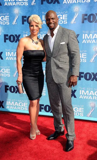 Mr. & Mrs. Crews - Terry Crews and Rebecca Crews walk the red carpet at the 42nd Annual NAACP Image Awards in Los Angeles. (Photo: Kristian Dowling/PictureGroup)