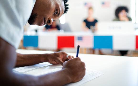 Guy writing on ballot