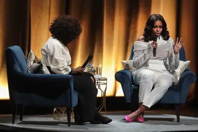 Angelic In All White&nbsp; - Our former first lady&nbsp;kicked off her first stop of&nbsp;Becoming&nbsp;book tour with Oprah last night (Nov. 13) in Chicago. She was angelic in all white wearing a sparkle off-the-shoulder white top, with high-waisted ivory pants from Sally LaPointe's fall 2018 collection and added the perfect pop of color with hot pink Stuart Weitzman pumps. (Photo: Scott Olson/Getty Images)
