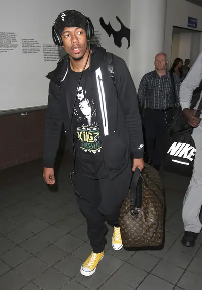 On the Go - Nick Cannon&nbsp;was spotted arriving at LAX airport with a large Louis Vuitton carry-on bag and bright yellow Converse All Stars. (Photo: PacificCoastNews)