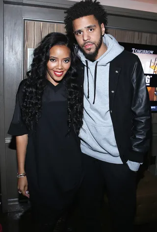 Crooked Smiles - Angela Simmons and an exhausted-looking&nbsp;J. Cole take a break backstage. (Photo: Jerritt Clark/Getty Images for Roc Nation)