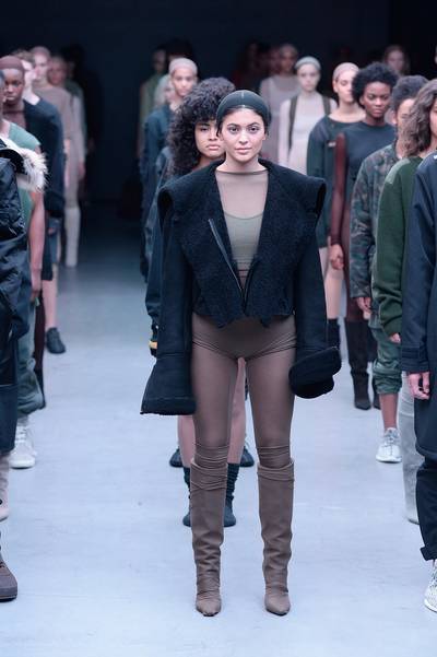 Kanye West x Adidas Originals - Yeezy?s sister-in-law Kylie Jenner makes her Adidas runway debut in a shearling coat with zip-open bell sleeves, worn with flesh-toned briefs and matching tights. The rapper?s collection is full of moody colors, military-inspired touches and comfy sweats. (Photo: Fernanda Calfat/Getty Images for adidas)