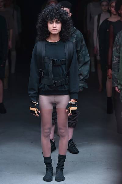 See-Through - Flesh-toned tights: not for your granny anymore. The rapper sent ladies out in sheer bodywear, teamed with slouchy socks, boxing gloves and sweatshirts with adjustable, military-inspired straps.&nbsp;  (Photo: Theo Wargo/Getty Images for adidas)