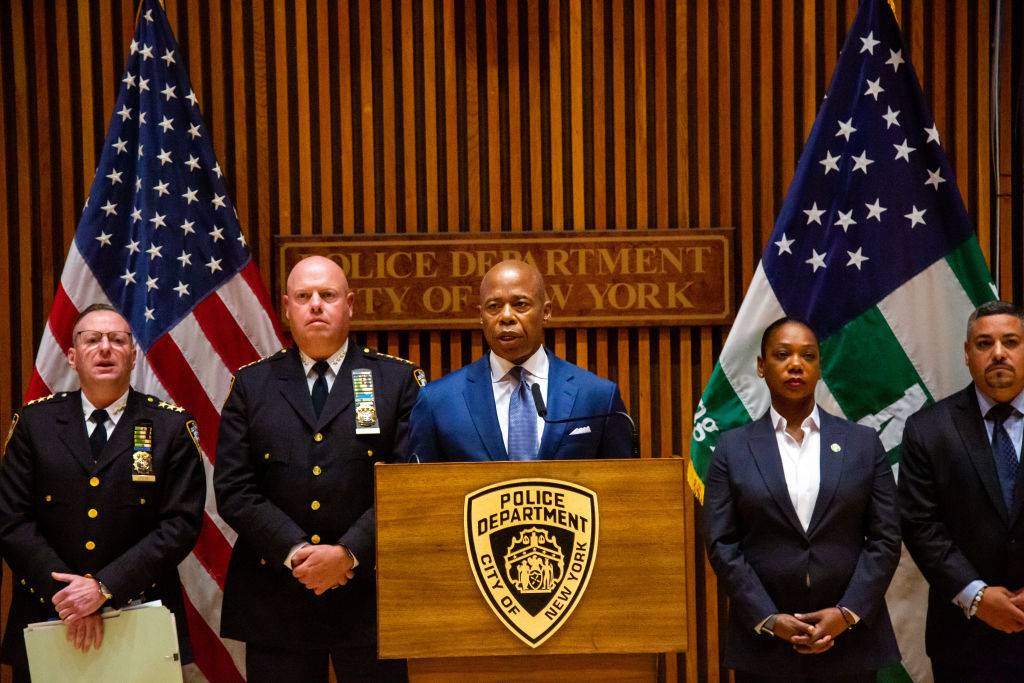 Eric Adams, mayor of New York, center, speaks beside Kenneth Corey, chief of department of the New York City Police Department (NYPD), center left, and Keechant Sewell, police commissioner of the New York City Police Department (NYPD), center right, during a news conference in New York, US, on Wednesday, Aug. 3, 2022.  