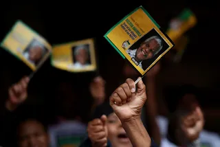 Waving Goodbye - People wave Mandela flags at Ellis Park in Johannesburg while watching a telecast of the memorial service.(Photo: Justin Sullivan/Getty Images)