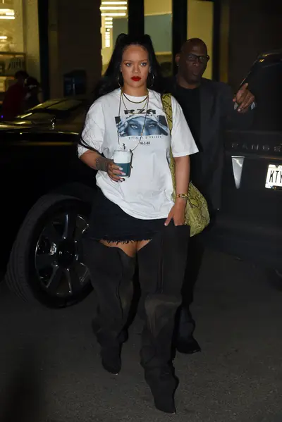 081622-style-rihanna-turns-a-nyc-street-into-her-runway-in-a-graphic-tee-denim-mini-skirt-and-thigh-high-boots.jpg