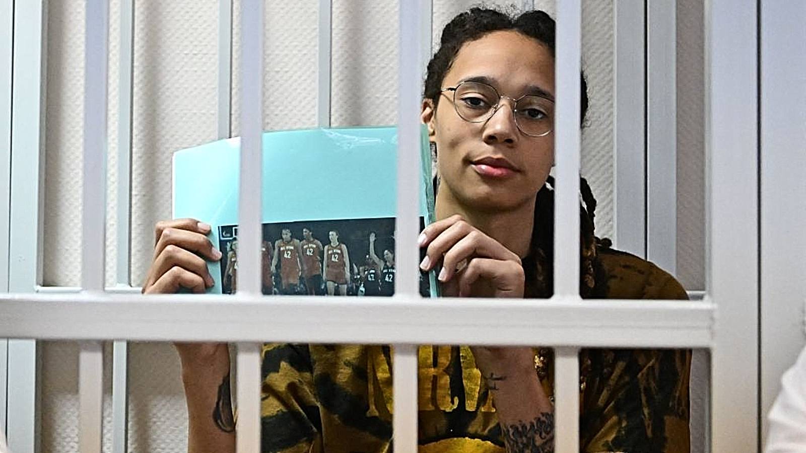 TOPSHOT - US WNBA basketball superstar Brittney Griner sits inside a defendants' cage during a hearing at the Khimki Court in the town of Khimki outside Moscow on July 15, 2022. 