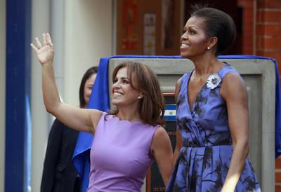 Dateline: San Salvador, March 22, 2011 - First lady of El Salvador Vanda Pignato and Obama respond to the cheers from the crowd during the inauguration of the Ciudad Mujer women's center in San Salvador, El Salvador.(Photo: Dario Lopez-Mills/AP Photo)