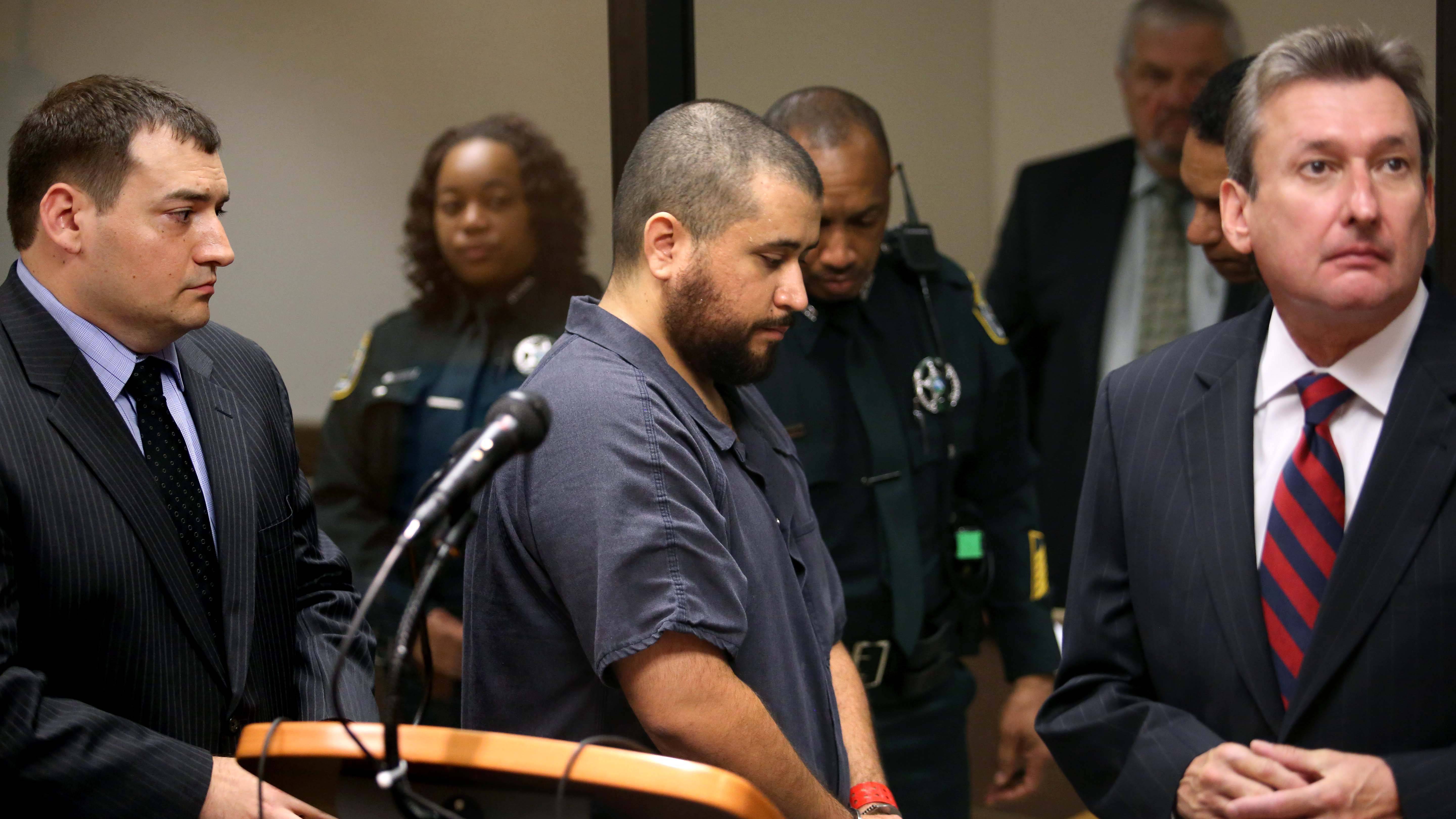 SANFORD, FL - NOVEMBER 19:  George Zimmerman, the acquitted shooter in the death of Trayvon Martin, leaves Courtroom J2 with his defense counsel Daniel Megaro (left) and Jeff Dowdy after a first-appearance hearing on charges including aggravated assault stemming from a fight with his girlfriend November 19, 2013 in Sanford, Florida. Zimmerman, 30, was arrested after police responded to a domestic disturbance call at a house. He was acquitted in July of all charges in the shooting death of unarmed, black teenager, Trayvon Martin.   (Photo by Joe Burbank-Pool/Getty Images)