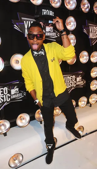 3. Black &amp; Yellow - Someone should have cued Wiz Khalifa's "Black &amp; Yellow" when Miguel hit the red carpet of the VMAs since he wore an all black outfit highlighted by a yellow cardigan. He completed the look with a bowtie and gave us one of his more tame and conservative outfits.(Photo: Anthony Harvey/PictureGroup)