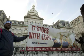It Stops With Cops - Demonstators hold up a sign calling for good cops to help end police violence against citizens and to gather outside of the Baltimore City Hall.&nbsp;(Photo: Jose Luis Magana, AP PHOTO)&nbsp;