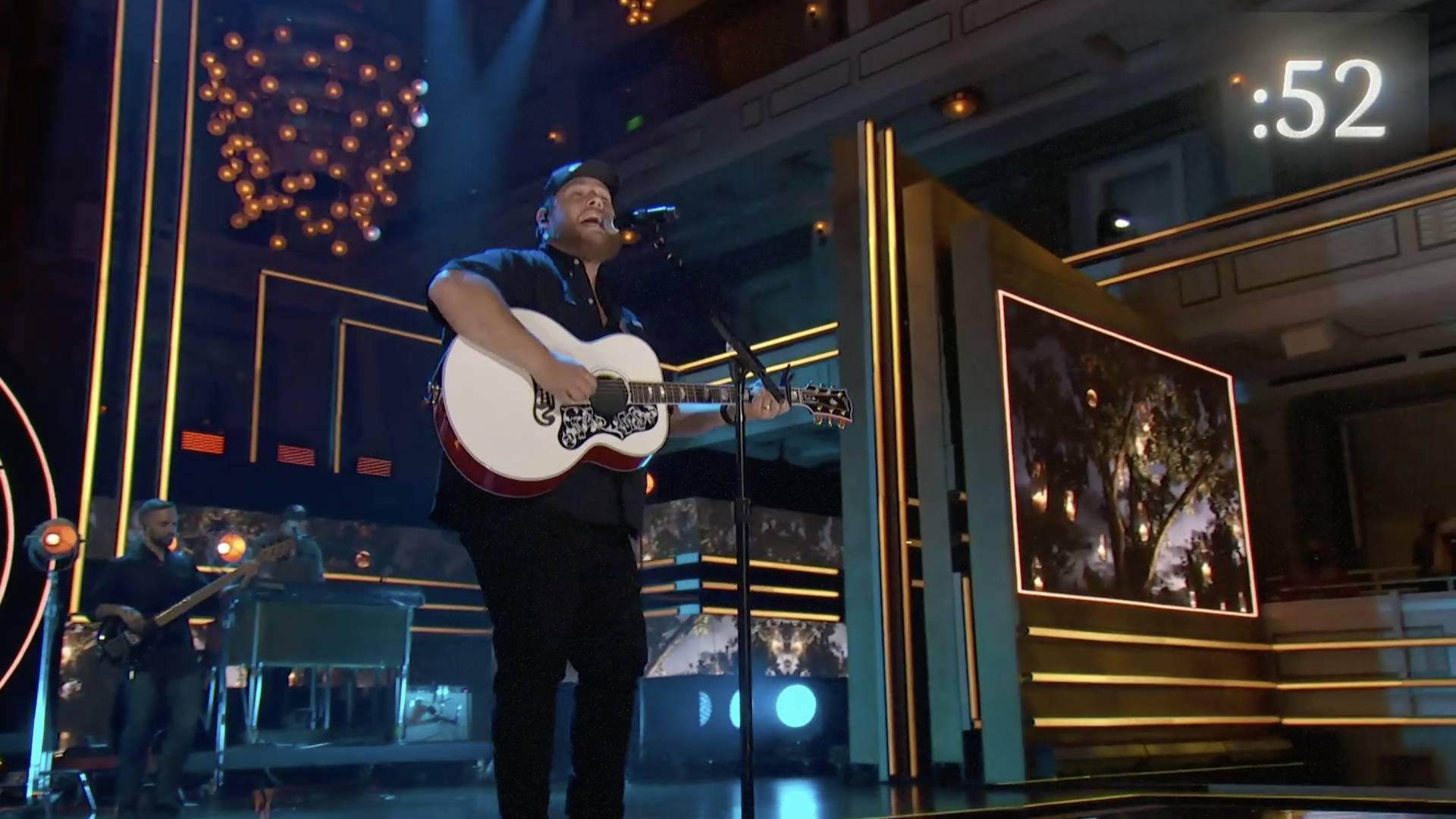 Luke Combs performing on stage at CMT Artist of the Year 2021.