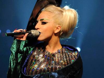 Lady Gaga keeps us thinking outside of the box with her sparkly green eye brows and blue lips.