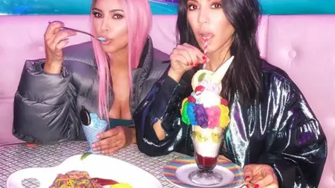 Kourtney Kardashian and Kim Kardashian in summer 2018