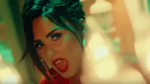 Demi Lovato in the video for 'Échame La Culpa' with Luis Fonsi