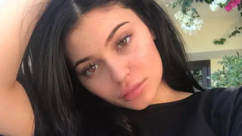Kylie Jenner fuels pregnancy rumours after she wears a coat in a heatwave 