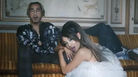 Ariana Grande with Mikey Foster and Scootie Anderson of Social House in the 'Boyfriend' music video