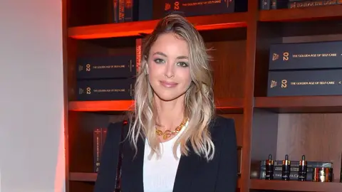 Kaitlynn Carter from 'The Hills' posing in white shirt, black blazer and gold chunky necklace 