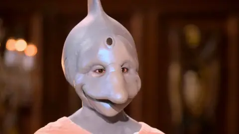 Sexy Beasts dolphin head costume netflix dating show dolphin smiling