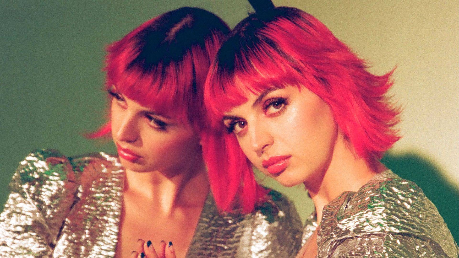 Rebecca Black Was Here press still reflection in mirror red hair and fringe shiny metallic top