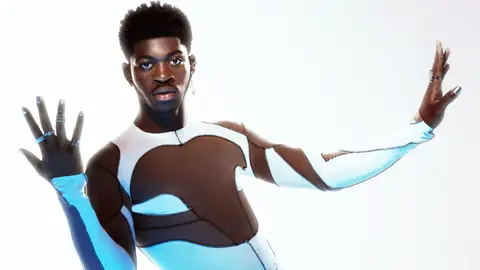 Lil Nas X in white and brown skintight shirt montero album release posing with nail polish silver