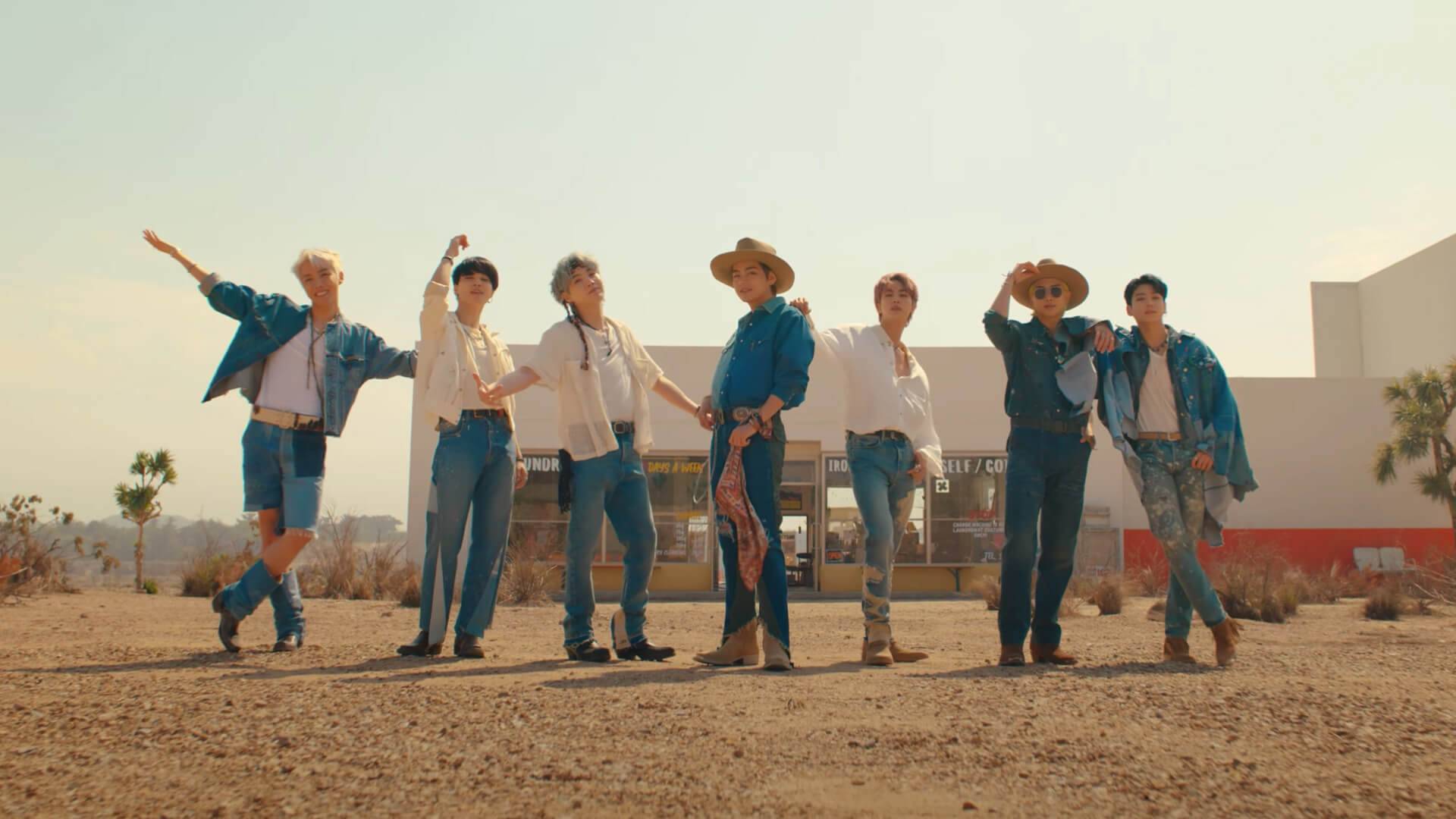 Members of BTS stand in a formation from screen capture from the Permission To Dance music video