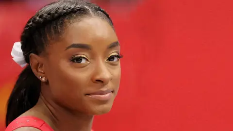 simone biles smiling at camera at olympics gymnast why she quit