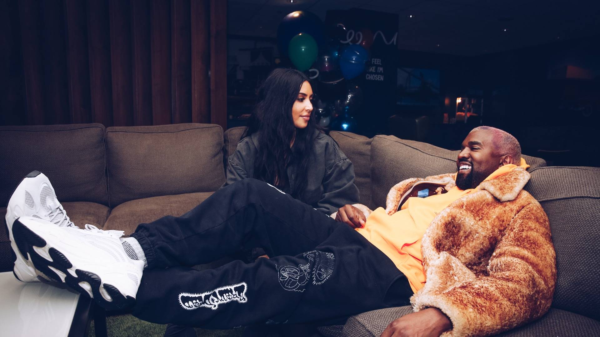 Kim Kardashian and Kanye West sitting on couch