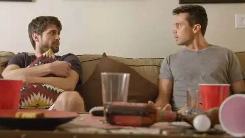 Stephen Colletti and James Lafferty in Everyone Is Doing Great new comedy about thirties sitting on couch scared