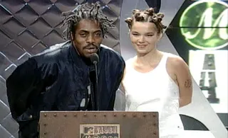 A VMA double-take! Presenters Coolio and Björk look like twinsies as they hit the stage with matching manes in 1994.