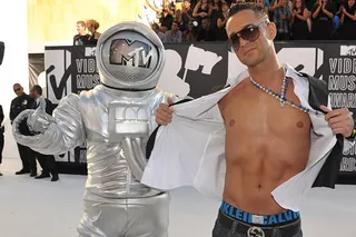 'Jersey Shore' star Mike "The Situation" shows off his infamous abs next to the Moonman at the 2010 VMAs.