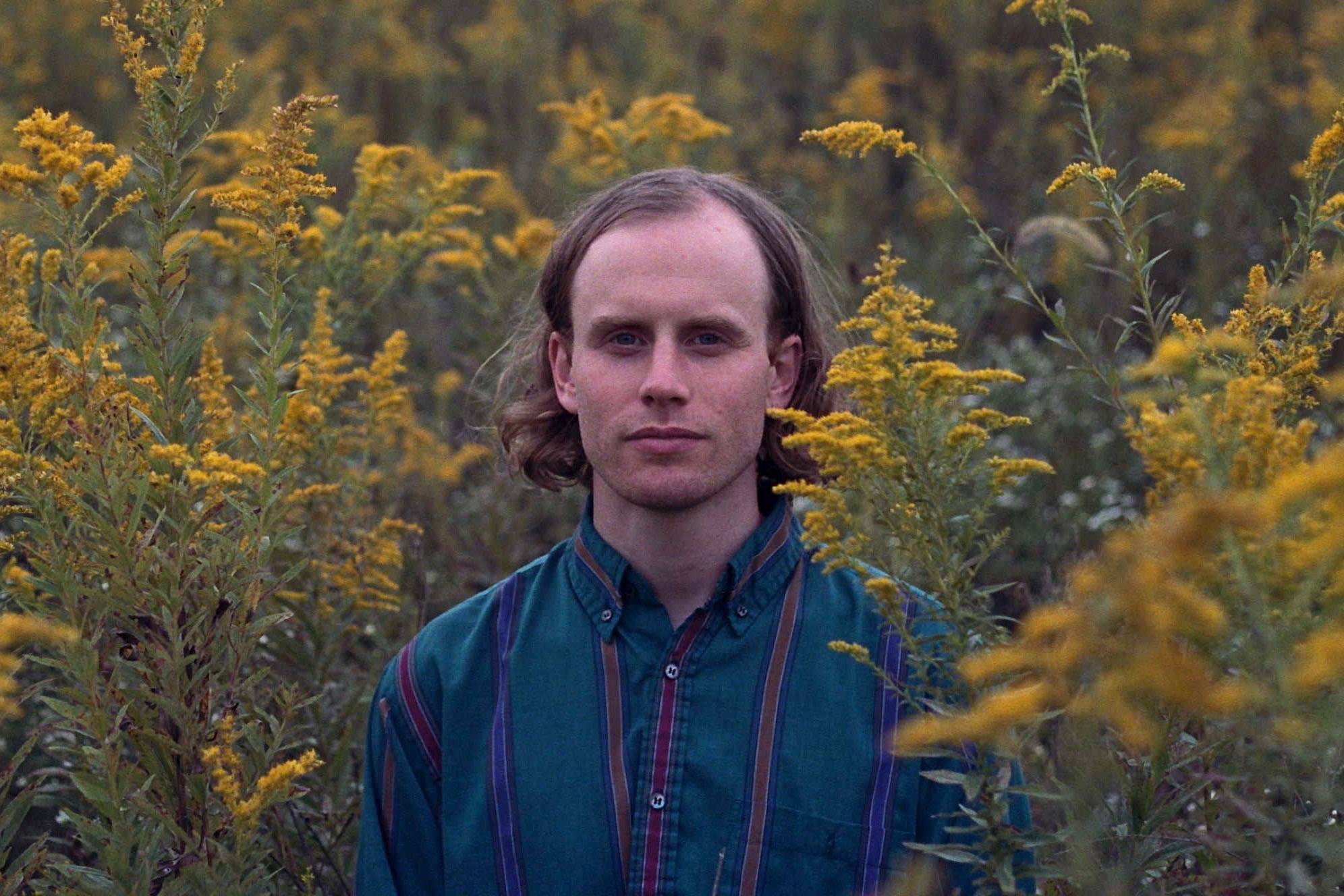 Superviolet's Steve Ciolek poses in a field of flora