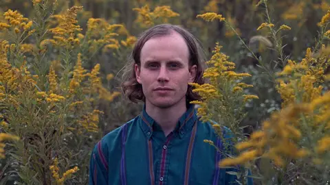 Superviolet's Steve Ciolek poses in a field of flora