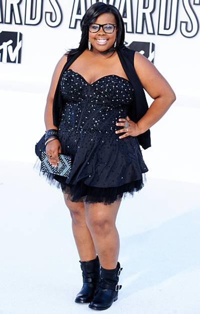 'Glee' star Amber Riley rocks an outfit that is the perfect blend of femininity and toughness: an embellished black mini dress and hard core moto boots at the 2010 VMAs.